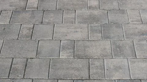 Close-up texture of gray rectangular paving slabs at an angle Stock Photos
