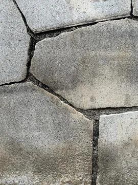 Close-up texture of grey stone pavement wall tiles background for design Stock Photos