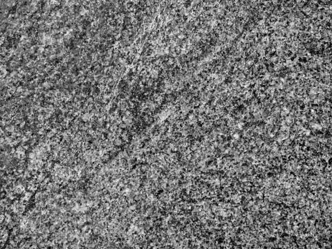 A close-up of a texture of a grinded black and white granite stone surface Stock Photos