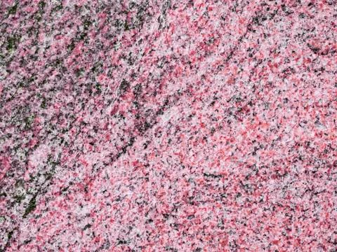 A close-up of a texture of a grinded deep rose granite stone surface Stock Photos