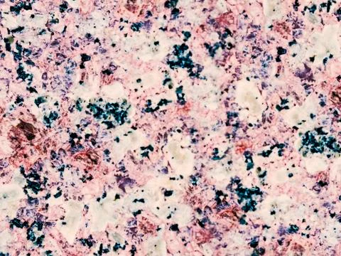 A close-up of a texture of a grinded rose granite stone surface Stock Photos