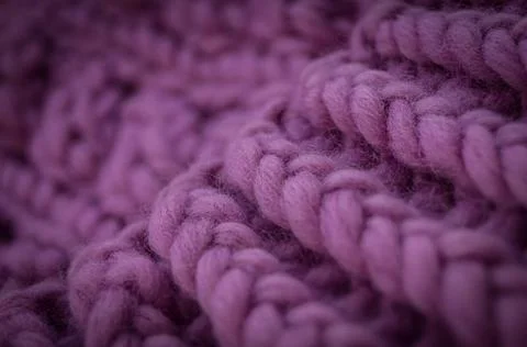 Close-up of the texture of a handmade knitted sweater. Rows of loops. Stock Photos
