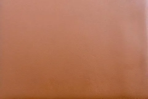 A close up texture image of rich brown tanned leather material surface Stock Photos