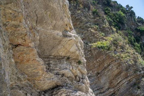 Close-up texture of layered ancient sedimentary rock layers on a coastal clif Stock Photos