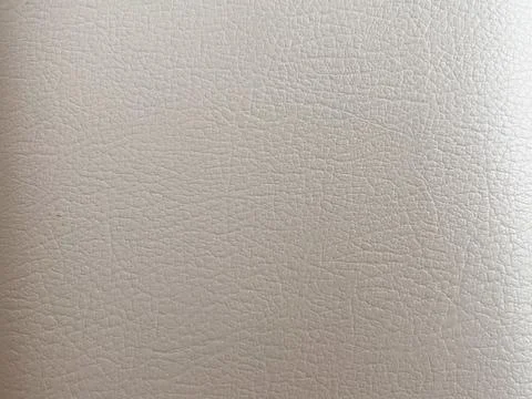A close-up texture of light beige or off-white faux leather Stock Photos