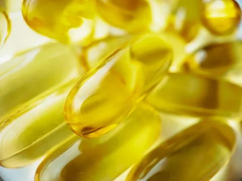 Close-up texture of many omega 3 capsules. Polyunsaturated fatty acids. The c Stock Photos