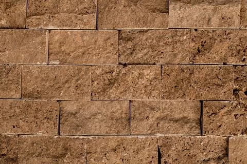 Close-up of texture of masonry of brown square stone block. Stock-Fotos