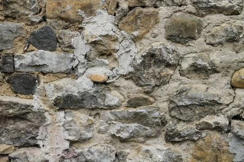 Close-up texture of a medieval stone wall in Soto, Aller, Asturias, Spain. Stock Photos