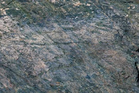 Close-up texture of a multi-toned metamorphic rock surface. Stock Photos