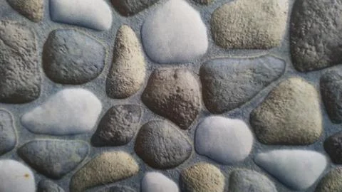 Close-up Texture of a Natural Stone Wall with Varied Colors and Shapes. Stock Photos