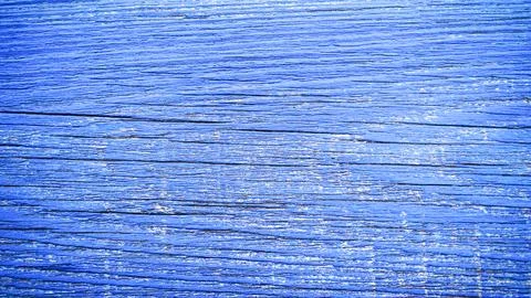 Close-up of the texture of an old wooden surface in bright blue color. Stock Photos