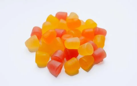 Close-up texture of orange and yellow multivitamin gummies in the form of bears Stock Photos