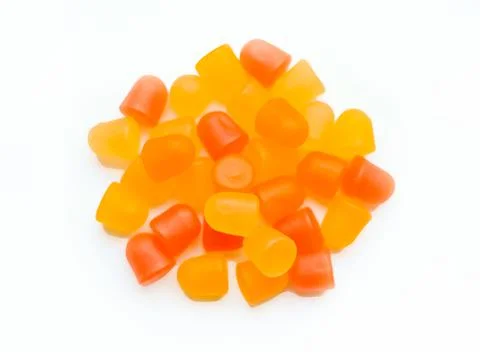 Close-up texture of orange and yellow multivitamin gummies in the form of bears Stock Photos