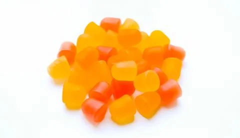Close-up texture of orange and yellow multivitamin gummies in the form of bears Stock Photos