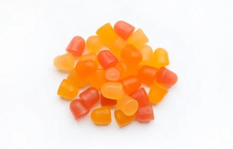 Close-up texture of orange and yellow multivitamin gummies in the form of bears Stock Photos