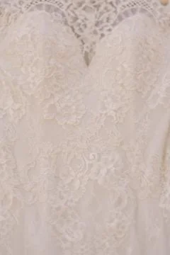 Close-up of the texture of the pattern of the bride's dress at the bust of the Foto stock