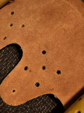 Close-Up Texture of Perforated Brown Suede in Almaty. Fotos Stock