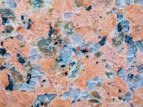 A close-up of a texture of polished red granite stone surface Stock Photos