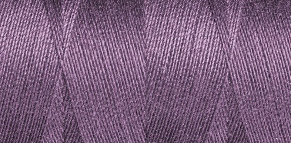 Close-up texture of Purple sewing threads on a spool Stock Photos