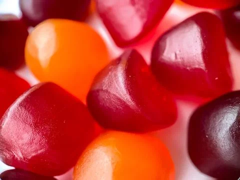 Close-up texture of red, orange and purple multivitamin gummies. Healthy life Stock Photos