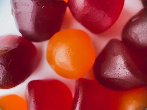 Close-up texture of red, orange and purple multivitamin gummies. Healthy life Stock Photos