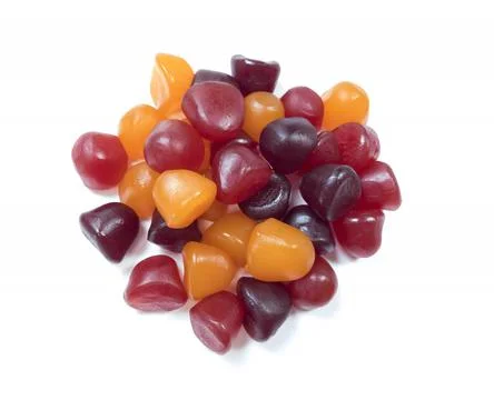 Close-up texture of red, orange and purple multivitamin gummies on white back Stock Photos
