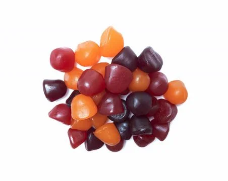Close-up texture of red, orange and purple multivitamin gummies on white back Stock Photos