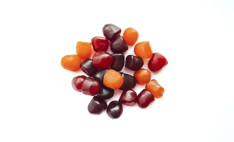 Close-up texture of red, orange and purple multivitamin gummies on white Stock Photos