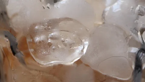 Close up texture red soft drink filling into glass with ice Vídeos de archivo 108590955