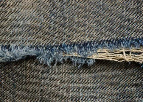 Close up texture of ripe destroyed torn jean Stock Photos