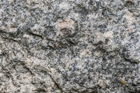 Close-up texture of rough granite rock with speckled patterns and subtle pi.. Stock Photos