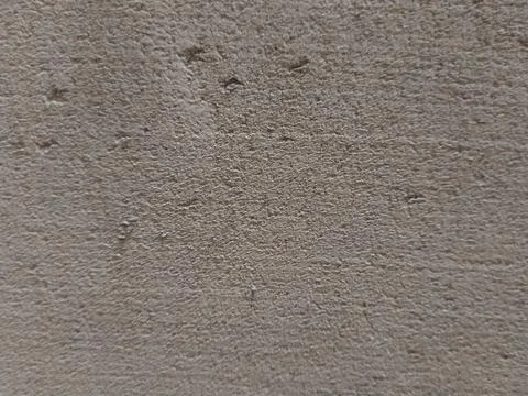 Close-up Texture of a Rough, Gray Concrete Surface with Small Pits. Stock Photos