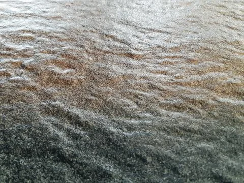 Close-up texture of rough natural stone surface with wavy ripples Stock Photos