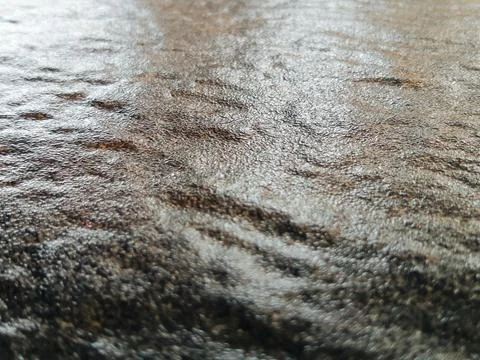 Close-up texture of rough natural stone surface with wavy ripples Stock Photos