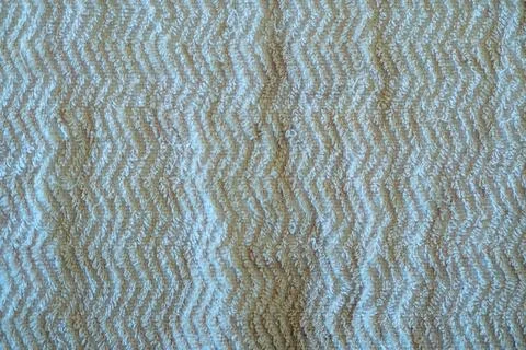 Close-up texture shot of a light beige bath towel with a distinct zigzag pa.. Stock Photos
