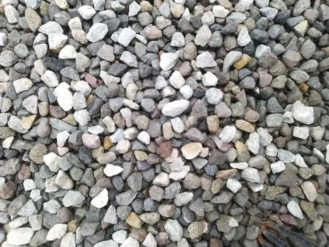 Close-up texture of small grey and white gravel stones. Stock Photos