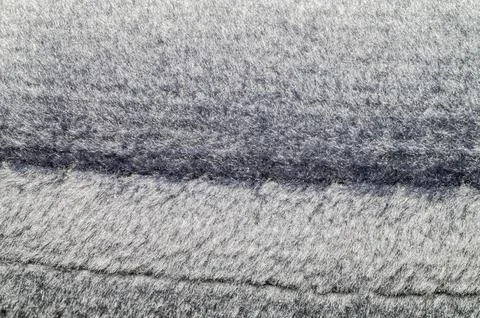 Close-up texture of a soft, fluffy grey fabric with a subtle sheen 스톡 사진