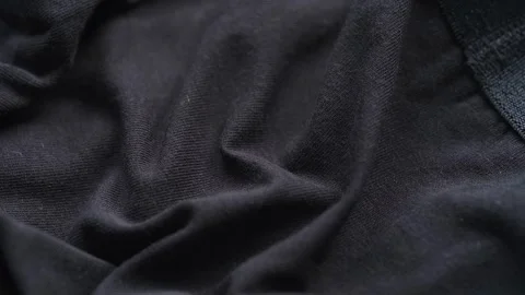 A close-up texture of soft wrinkled black jersey fabric. Stock Footage 340405193
