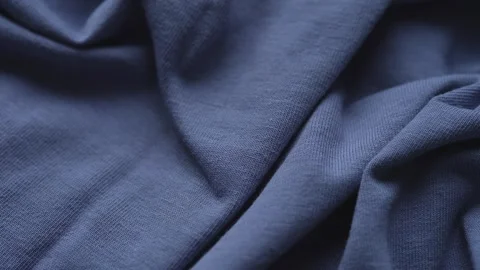 A close-up texture of soft wrinkled blue jersey fabric. Stock Footage 340022203