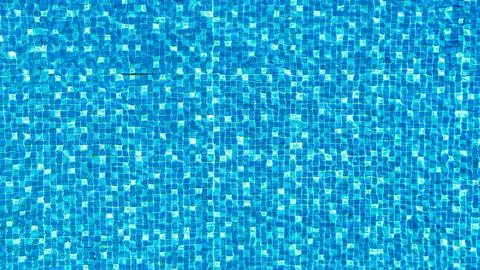 Close-up texture of sparkling blue pool water under sunlight Stock Photos