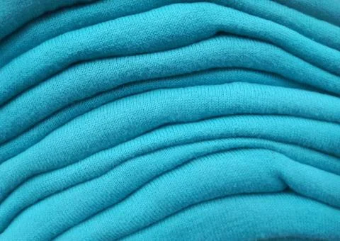 Close up texture stack of green tosca sweaters Stock Photos