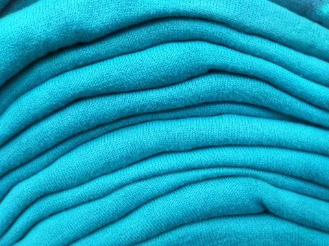 Close up texture stack of green tosca sweaters Stock Photos