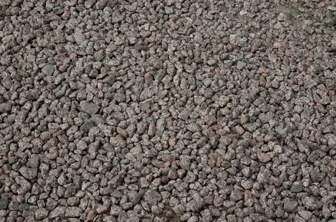 Close-up texture of a surface covered entirely with fine crushed stone. Stock Photos