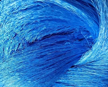Close-up texture of vibrant blue raw silk yarn with glossy shine Stock Photos