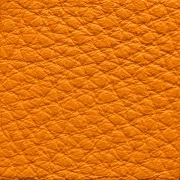 Close-up texture of vibrant orange pebbled leather grain Stock Photos