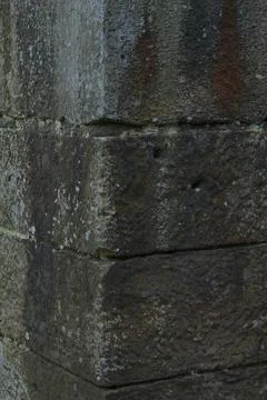Close-up texture of weathered gritstone blocks from an industrial era structure. Stock Photos