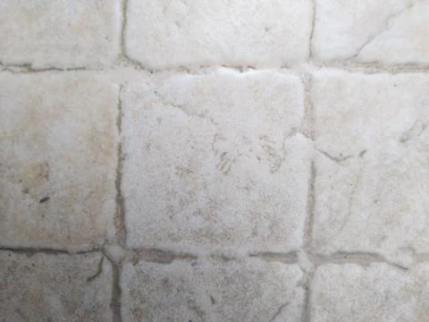 Close-up texture of weathered stone tiles with subtle color variations. Stock Photos