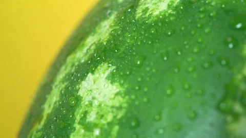 A close up of Texture wet Watermelon on yellow background Stock Footage 156842376