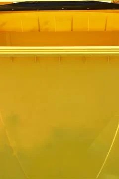 Close up texture of a yellow plastic waste container Stock-Fotos