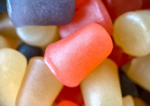 Close-up texture of yellow, red and pink multivitamin tablets in form of fruits Stock Photos